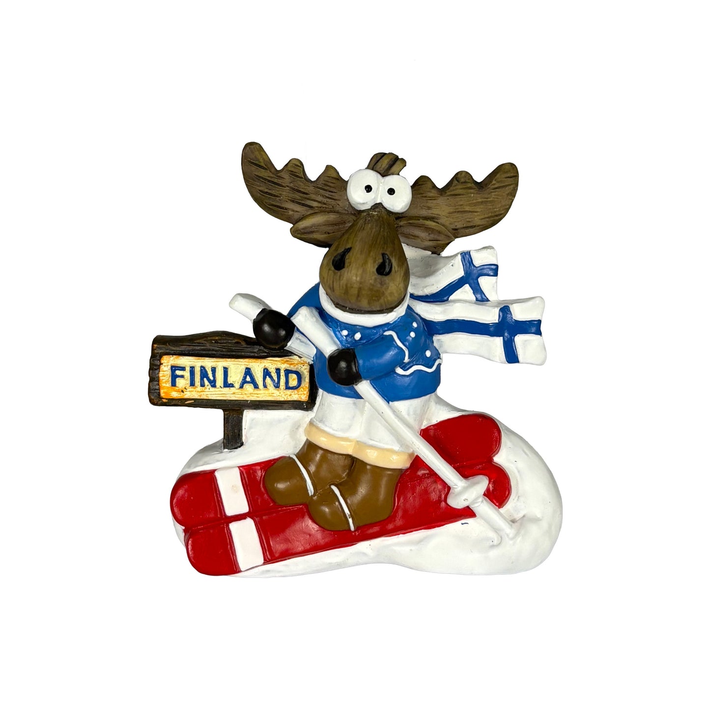 Magnet med skidåkande älg i blå tröja, röda skidor och halsduk med finska flaggan. En lekfull souvenir med finsk vinterkänsla.
