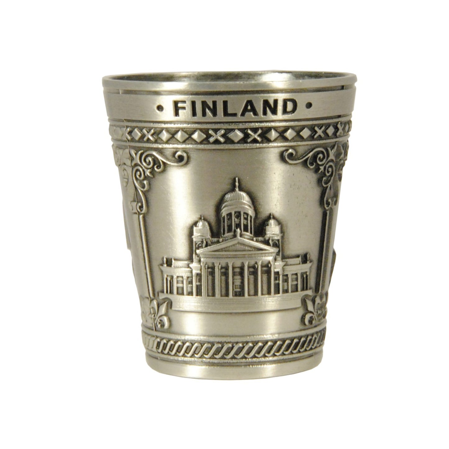 Sida av metallshotsglas med reliefmotiv av Helsingfors domkyrka och texten 'Finland' – ett av tre motiv på denna populära souvenir.