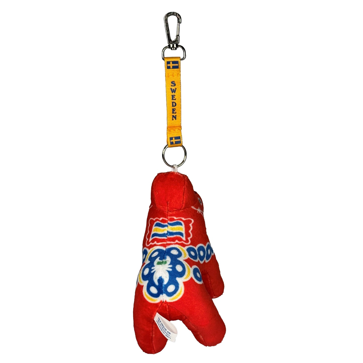 Mjuk dalahäst med gult keyband med två svenska flaggor och texten "SWEDEN". Sedd bakifrån.