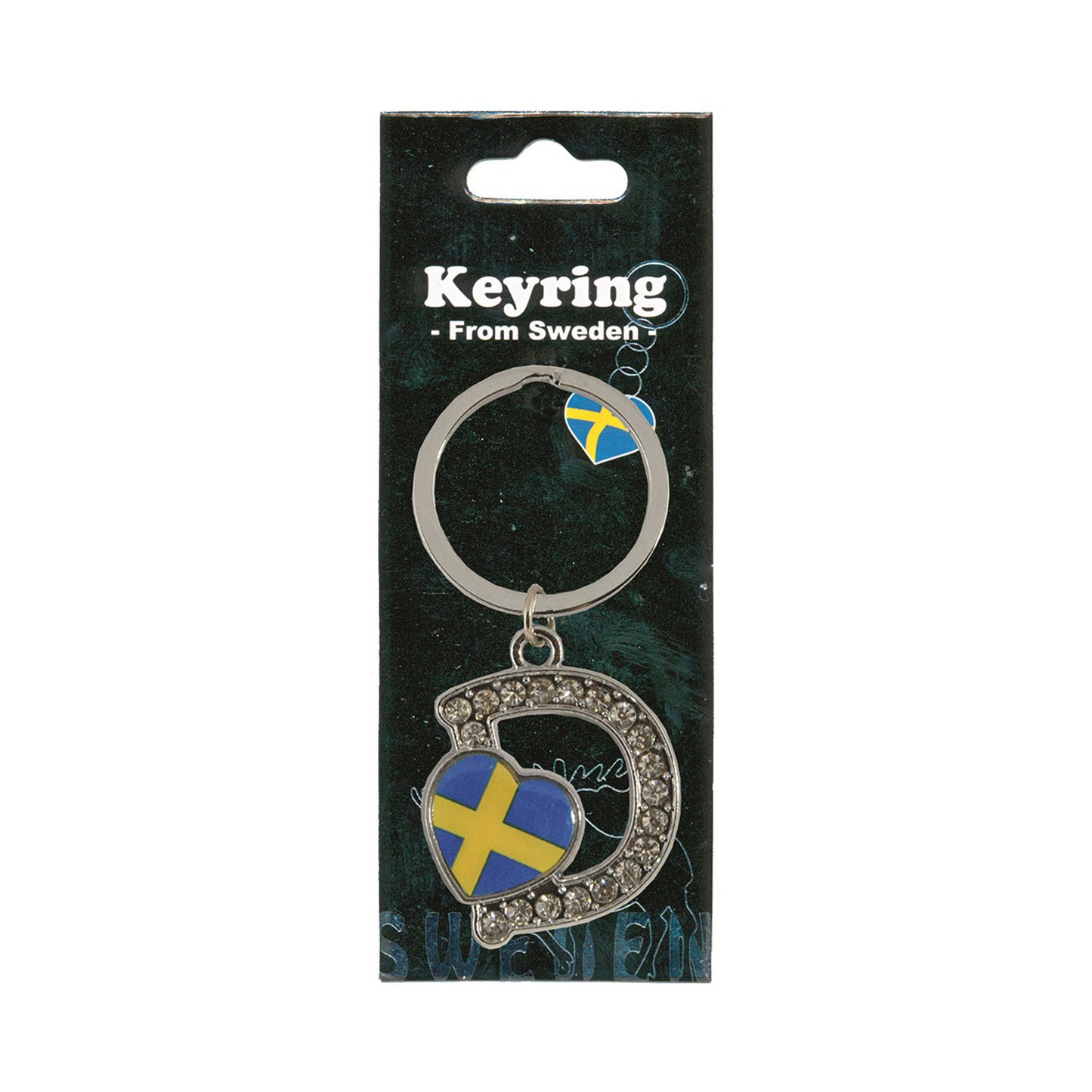 Metallnyckelring med bokstaven D. Bokstaven är dekorerad med glitterstenar. På bokstaven finns även ett hjärta med en svensk flagga. Visas här i sin förpackning. Svart förpackning med texten "Keyring från Sweden" i vitt.