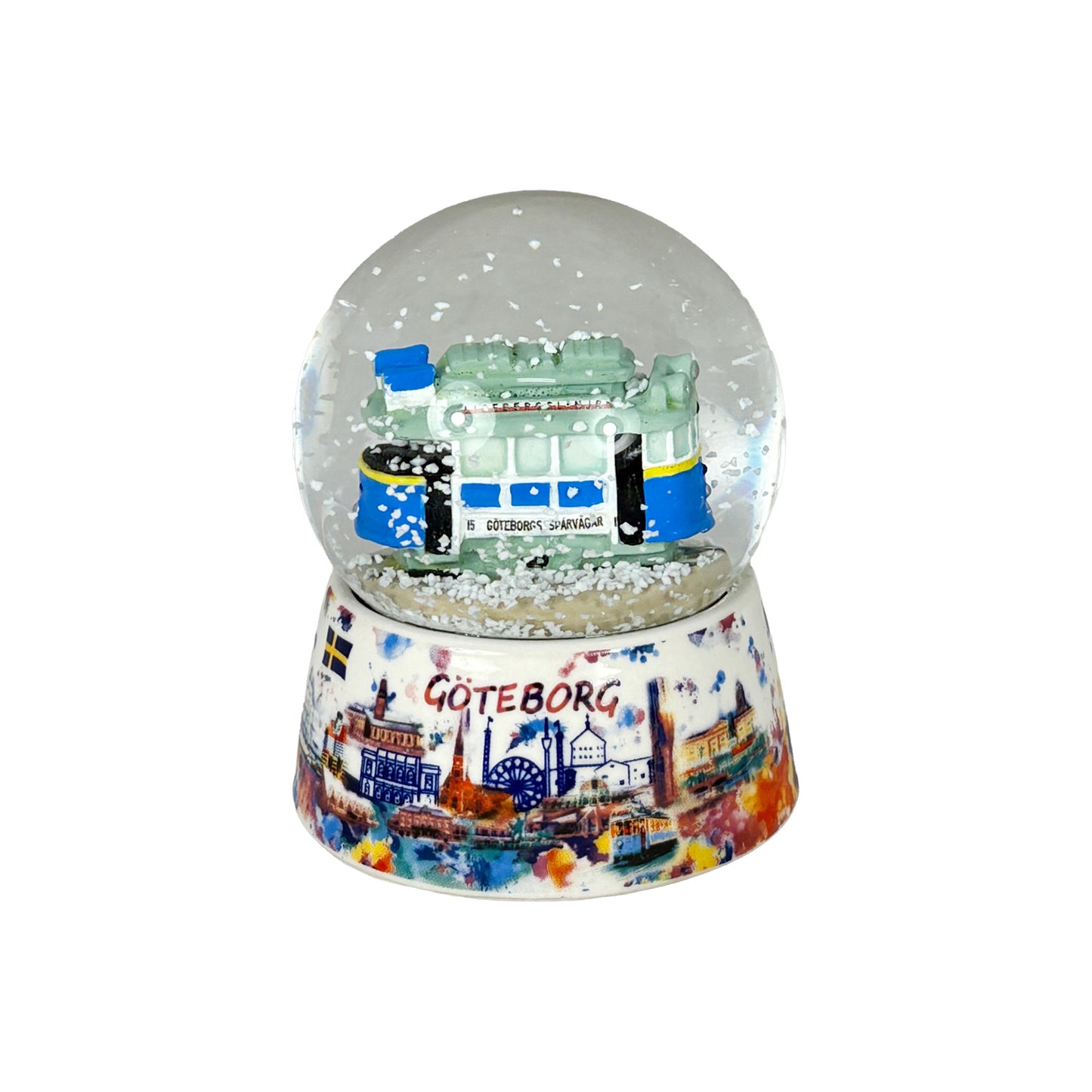 Vattenglob med en klassisk spårvagn från Göteborg inuti, med yrande snöflingor.