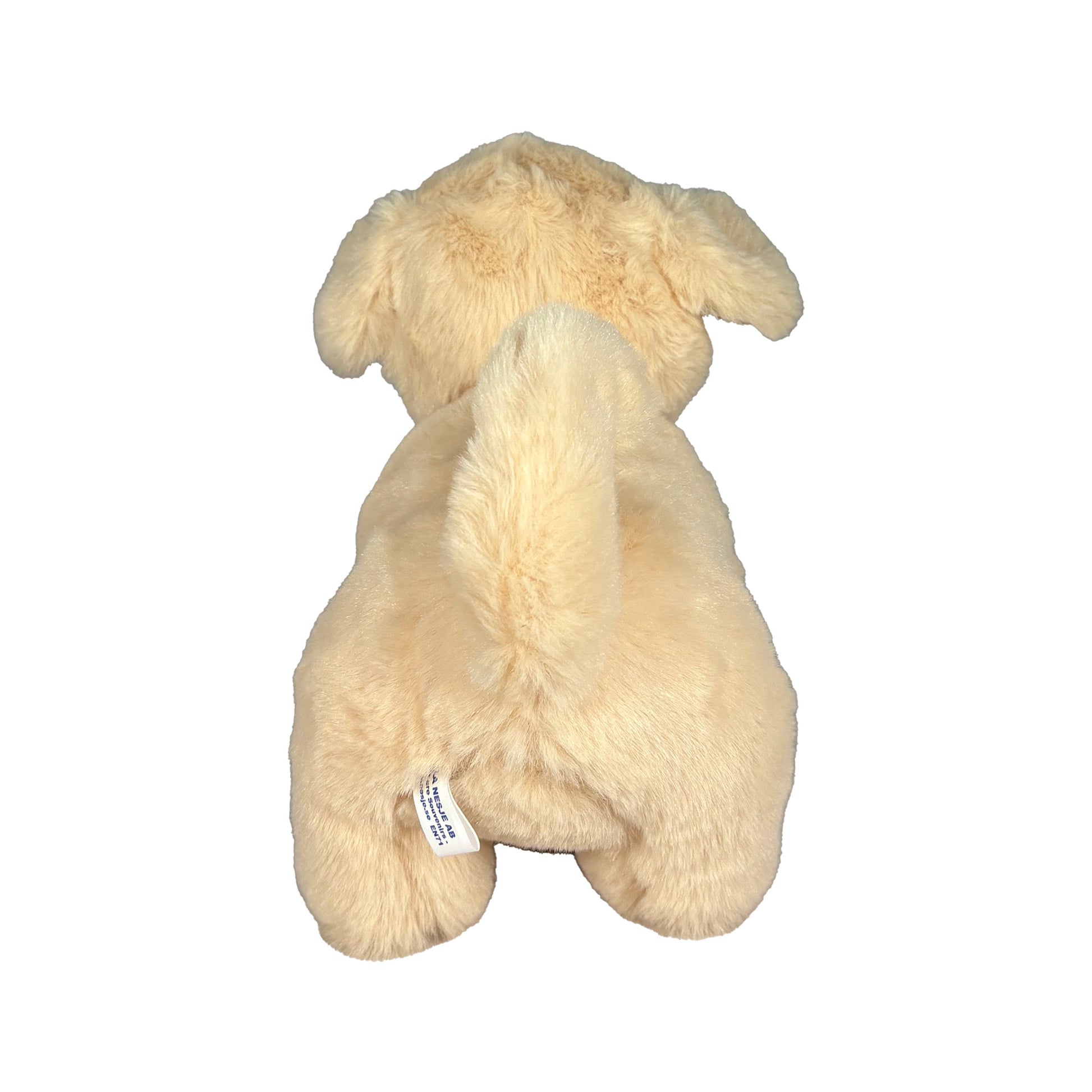 Beige Gosedjurshund sedd bakifrån.