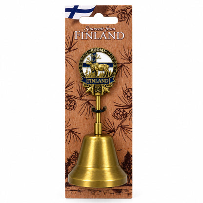 Guldfärgad bordsklocka i metall med ren framför finska flaggan och hängetikett med texten ”Souvenir from FINLAND”.