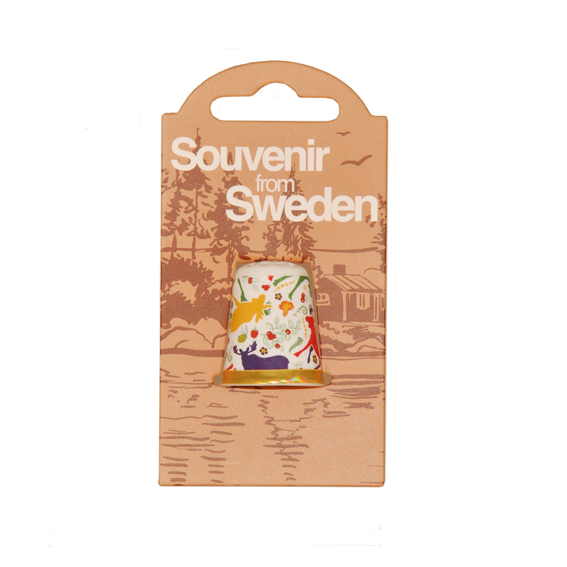 Förpackning med fingerborg i porslin med motiv av färgglada älgar. På förpackningen står det "Souvenir from Sweden".