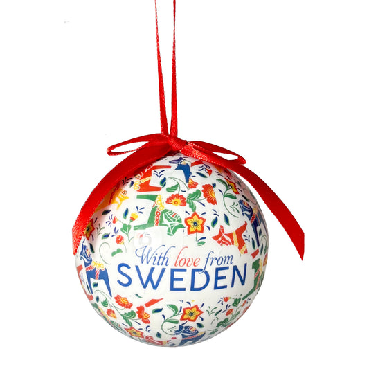 Julkula med färgglada dalahästar och rött band, samt texten "With love from Sweden".