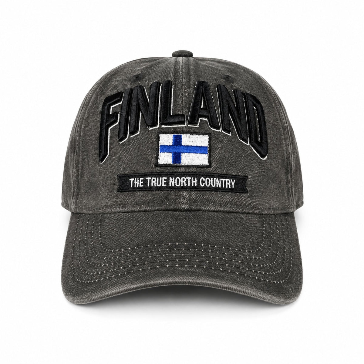 Grå vaxad keps sedd framifrån med broderad finsk flagga och texten Finland i 3D. Den vaxade ytan ger kepsen en distinkt look och känsla.