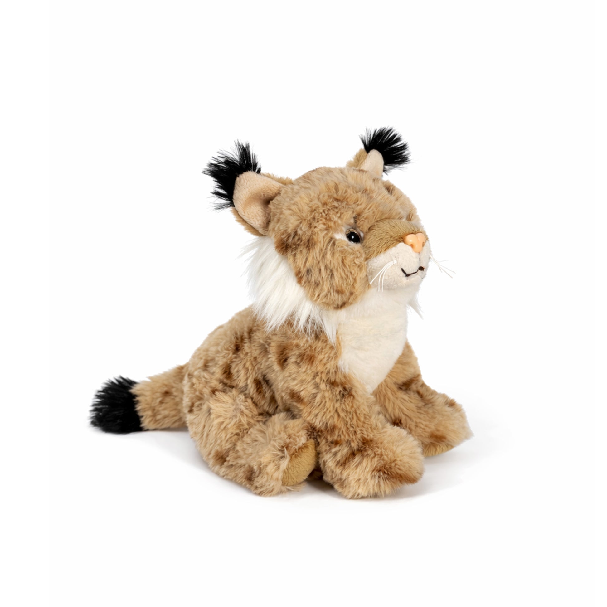 Beige sittande gosedjurs lodjur med bruna prickar och svarta tofsar på öronen, sedd snett framifrån.