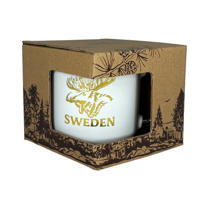 Muggen i dekorativ förpackning av brun kartong med skogsmotiv.
