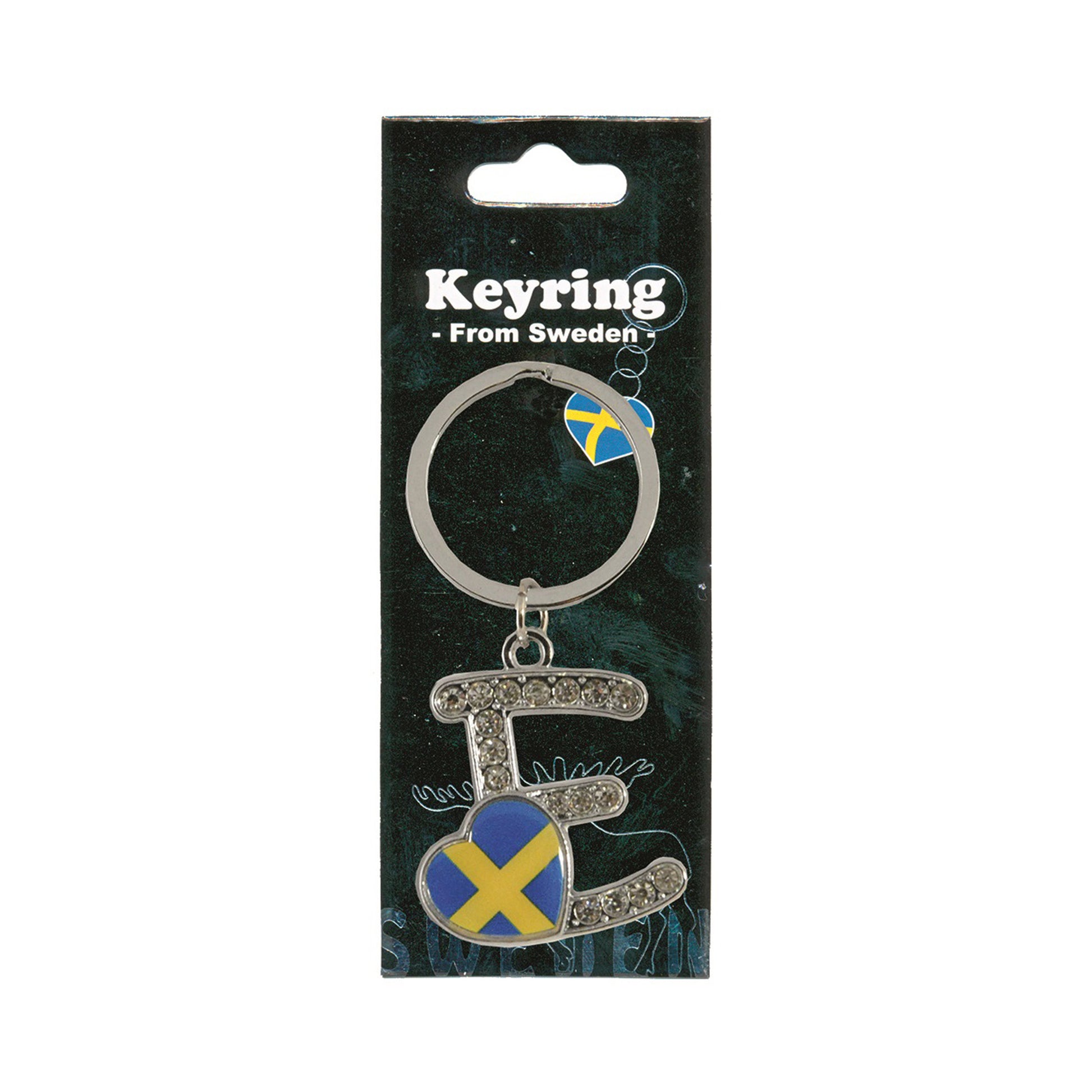 Metallnyckelring med bokstaven E. Bokstaven är dekorerad med glitterstenar. På bokstaven finns även ett hjärta med en svensk flagga. Visas här i sin förpackning. Svart förpackning med  texten "Keyring från Sweden" i vitt.