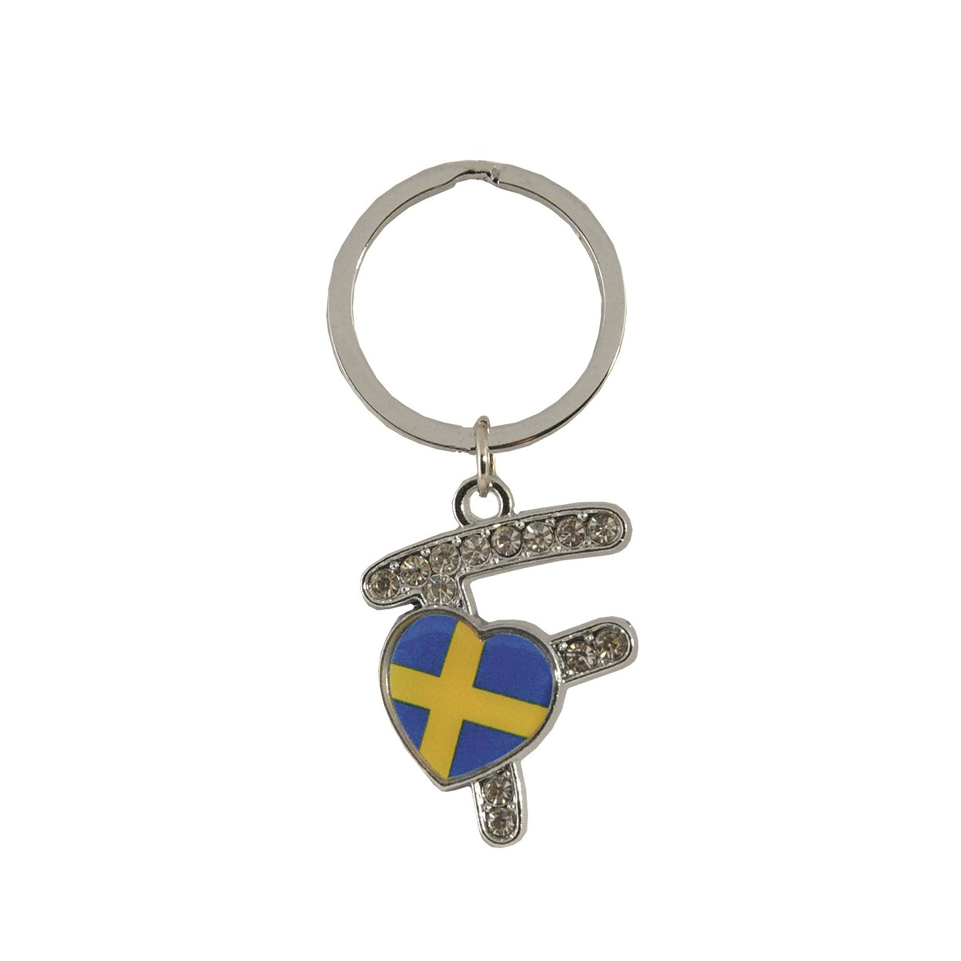 Metallnyckelring med bokstaven F. Bokstaven är dekorerad med glitterstenar. På bokstaven finns även ett hjärta med en svensk flagga.