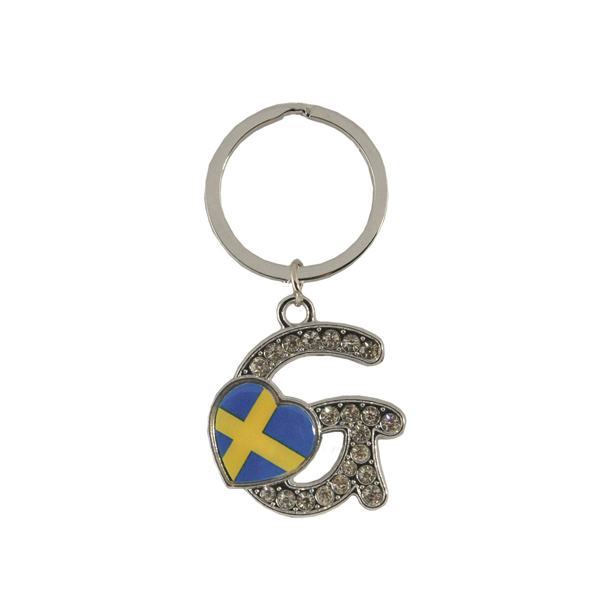 Metallnyckelring med bokstaven G. Bokstaven är dekorerad med glitterstenar. På bokstaven finns även ett hjärta med en svensk flagga.