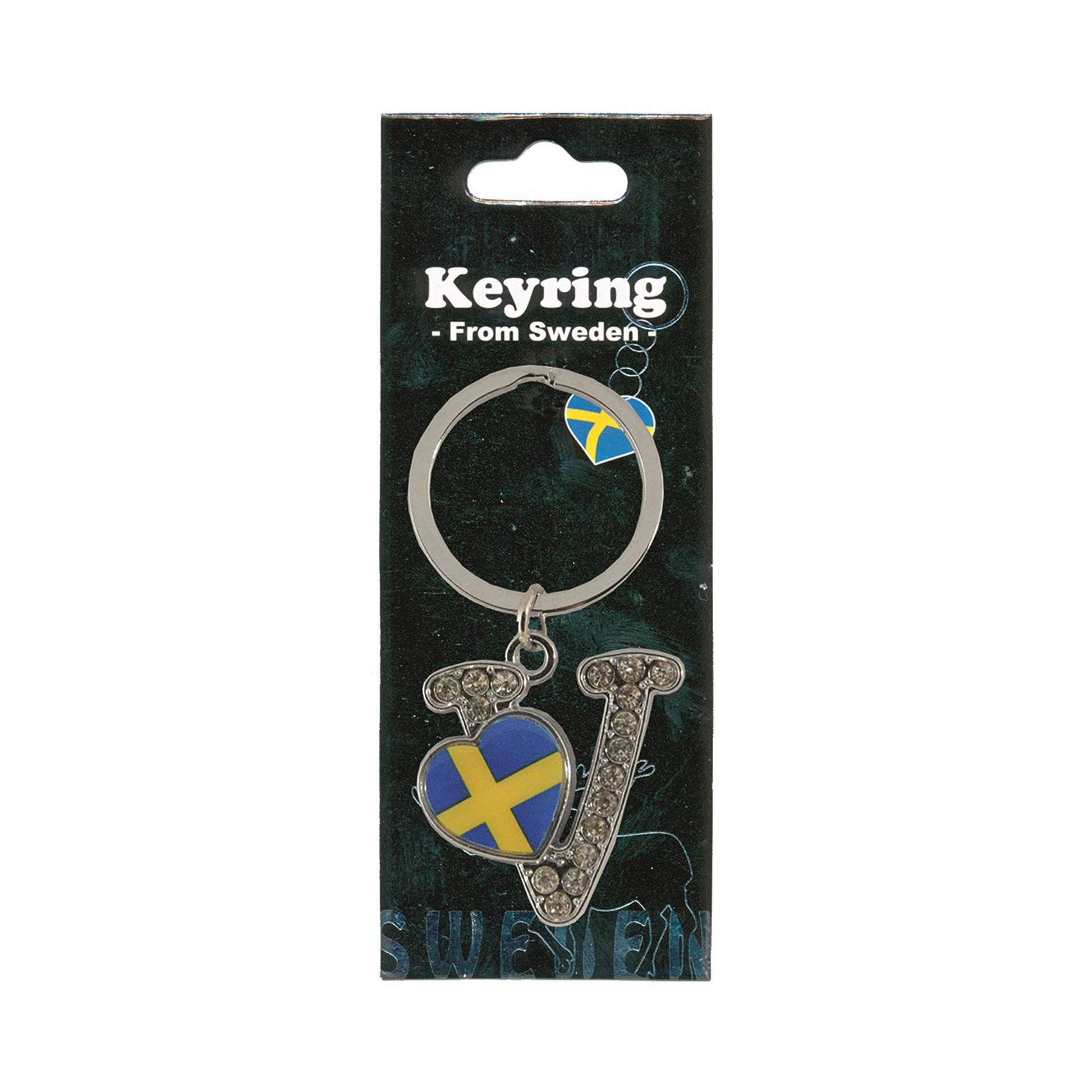 Metallnyckelring med bokstaven V. Bokstaven är dekorerad med glitterstenar. På bokstaven finns även ett hjärta med en svensk flagga. Visas här i sin förpackning. Svart förpackning med  texten "Keyring från Sweden" i vitt.