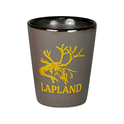 Grått shotglas med guldfärgat renhuvud och texten "Lapland".