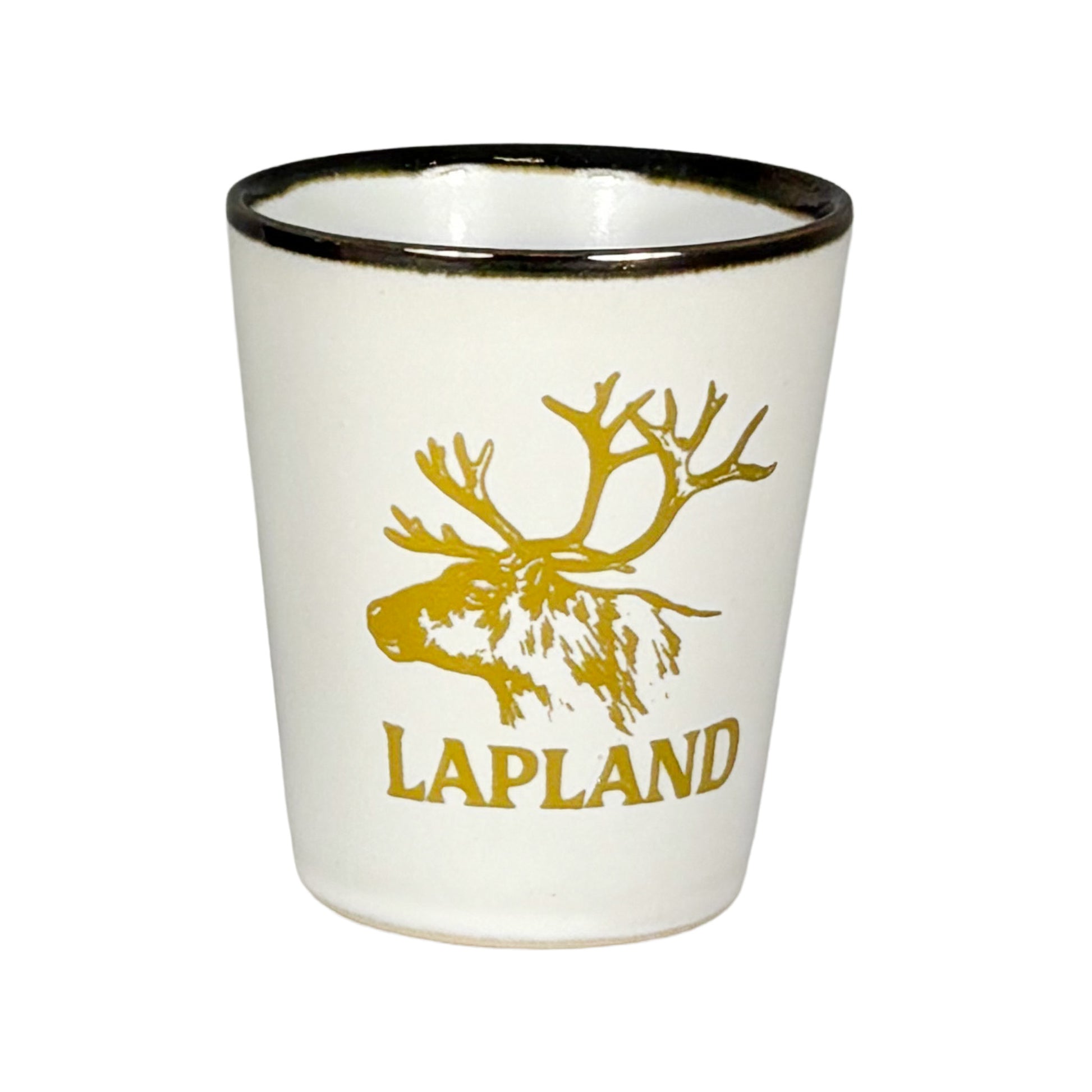 Vitt shotglas med guldfärgat renhuvud och texten "Lapland".