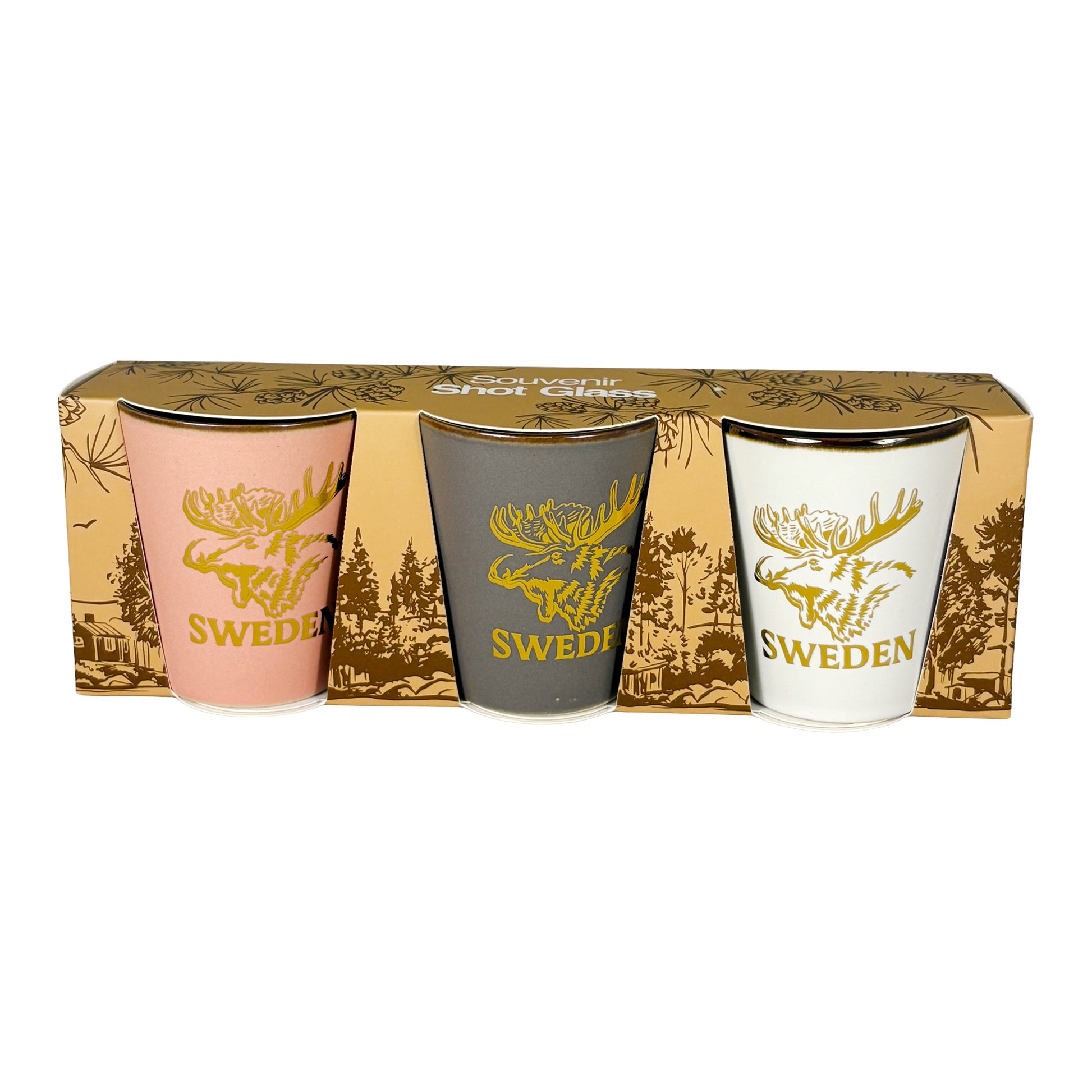 Tre shotglas ett rosa, ett vitt och ett grått. Alla med guldfärgat älghuvud och texten "Sweden". Visas här framifrån i sin förpackning. 