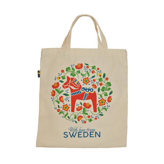 Tygkasse med klassisk dalahäst, texten "with love from Sweden", blommor och svensk flagga i kanten.