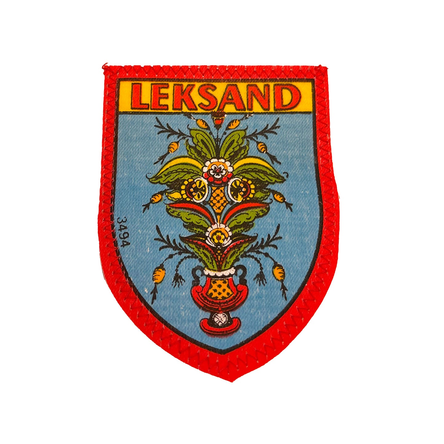 Tygmärke med kurbitsmotiv från Leksand – klassiskt souvenirmärke i vintage stil, 60x82 mm, perfekt att sy fast på jacka, väska eller ryggsäck.
