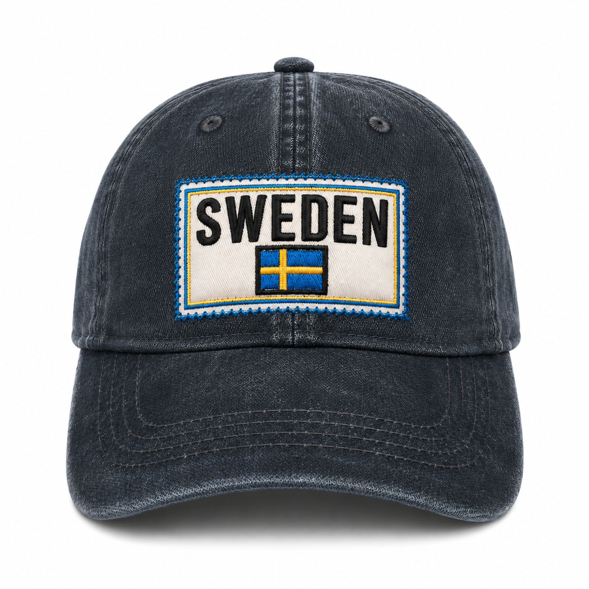 Blå vaxad keps med svensk flagga och texten "SWEDEN". Sedd rakt framifrån.
